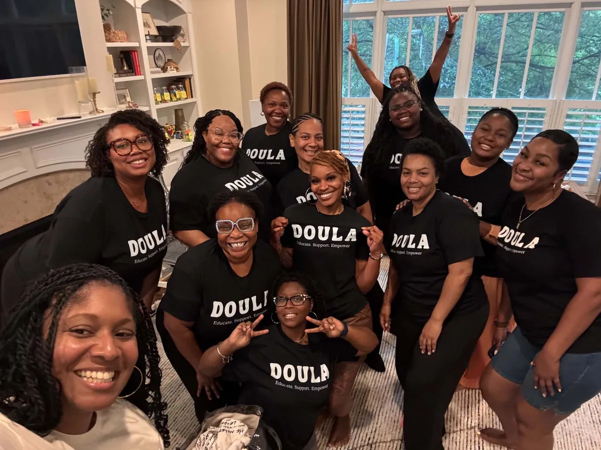LaTesha with her full doula training cohort in Doula Educate Support Empower shirts at Full Bloom Birthings